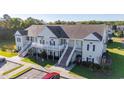Aerial view showing a light tan building with multiple units and surrounding landscape at 111 Portsmith Dr. # 6, Myrtle Beach, SC 29588