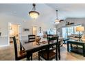 Dining area with a table and chairs, adjacent to the living room at 4880 Dahlia Ct. # 305, Myrtle Beach, SC 29577