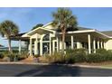 Community clubhouse with a covered porch and landscaping at 4893 Magnolia Pointe Ln. # 103, Myrtle Beach, SC 29577