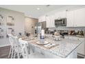 Modern kitchen with white cabinets, granite countertops, and stainless steel appliances at 651 Wallace Dr., Little River, SC 29566