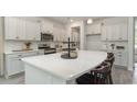 Modern kitchen with white cabinets, quartz countertops, and an island at 555 Haven View Way, Murrells Inlet, SC 29576