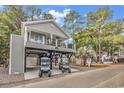 Two-story home with elevated parking and golf carts at 6001 - 1537 S Kings Hwy., Myrtle Beach, SC 29575