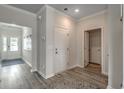 Bright foyer with wood-look floors and access to other rooms at 115 Arrow Wood Dr, Conway, SC 29526