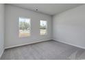 Spacious bedroom with neutral carpeting and large windows at 316 Garden Grove St, Conway, SC 29526