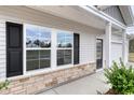 House exterior showcasing a front door, stone accents, and shutters at 219 Sundrop Way, Conway, SC 29526