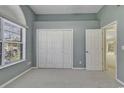 Bedroom with carpet, large window, and double closet at 4542 Mandi Ave., Little River, SC 29566