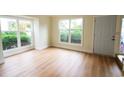 Bright living room with large windows, light walls, and wood-look flooring at 4115 Little River Rd. # 6F, Myrtle Beach, SC 29577