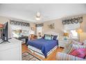 Bright bedroom with a comfy queen bed, window seating and a ceiling fan at 241 Atlantic Ave., Pawleys Island, SC 29585