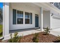 Front porch of two story home with white siding and blue accents at 2473 Campton Loop, Conway, SC 29527