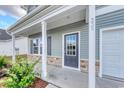 Front porch with gray door, white columns, and stone accents at 320 Garden Grove St, Conway, SC 29526