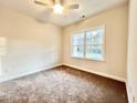 Cozy bedroom with neutral carpet, ceiling fan, and large window offering natural light at 4967 Old State Highway 90, Conway, SC 29526