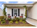 Relaxing front porch with rocking chairs, landscaping, and a charming covered area at 2022 Wilbraham Dr., Myrtle Beach, SC 29579