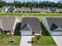 Aerial view of houses with lakefront access in a neighborhood at 2477 Campton Loop, Conway, SC 29527