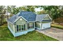 Aerial view of a green house with a gravel driveway at 3723 Choppee Rd., Georgetown, SC 29440