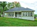Rear view of a green house with a deck and large windows at 3723 Choppee Rd., Georgetown, SC 29440