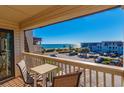 Spacious balcony with table and chairs, boasting stunning ocean views and beach access at 5601 N Ocean Blvd. # C-314, Myrtle Beach, SC 29577