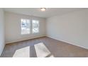 Bright bedroom with neutral carpeting and two large windows at 819 Busy Corner Rd., Conway, SC 29527