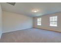 Spacious bedroom with neutral walls, carpet flooring, and two windows at 889 Busy Corner Rd., Conway, SC 29527