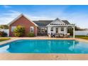 Inviting backyard oasis featuring a refreshing pool and pergola at 148 Highmeadow Ln., Aynor, SC 29511