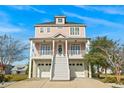 Two-story house featuring a charming pink exterior and two-car garage at 338 Harbour View Dr., Myrtle Beach, SC 29579