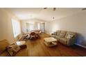 Spacious living room with hardwood floors, seating area, and dining area at 425 Spauldingwood Rd., Little River, SC 29566