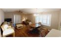 Living room with wood floors, seating area, and dining table at 425 Spauldingwood Rd., Little River, SC 29566