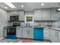 Modern kitchen with gray cabinets, granite counters, and blue appliances at 1109 Cypress Cove, North Myrtle Beach, SC 29582
