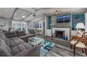 Bright living room with a fireplace, sectional sofa, and beachy decor at 1109 Cypress Cove, North Myrtle Beach, SC 29582