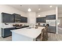 Modern kitchen with white quartz island and dark cabinetry at 1849 Brook Park Pl., Conway, SC 29526