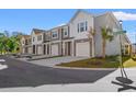 Row of townhomes viewed from the street, showing gray and white siding and garages at 237 Sandridgebury Dr. # 58, Little River, SC 29566