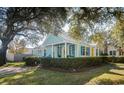 Light blue cottage with metal roof, landscaping, and yellow front door at 332 N Congdon St., Georgetown, SC 29440