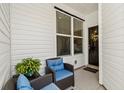 Cozy front porch with seating and a welcoming wreath on the door at 4036-D Taranto Loop # 5404-D, Myrtle Beach, SC 29579