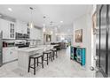 Modern kitchen with white cabinets, island, and marble flooring at 4036-D Taranto Loop # 5404-D, Myrtle Beach, SC 29579