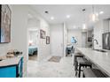 Open concept kitchen with breakfast bar and view into living room at 4036-D Taranto Loop # 5404-D, Myrtle Beach, SC 29579