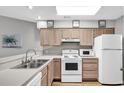 Bright kitchen with white appliances and wood cabinets at 4103 Pinehurst Circle # Bb-14, Little River, SC 29566