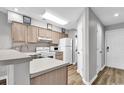 Galley kitchen with white appliances and wood cabinets at 4103 Pinehurst Circle # Bb-14, Little River, SC 29566