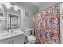 Small bathroom with floral shower curtain and white vanity at 4818 Innisbrook Ct. # 603, Myrtle Beach, SC 29579