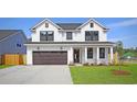 Two-story white house with brown garage door and manicured lawn at 5118 Middleton View Dr., Myrtle Beach, SC 29579