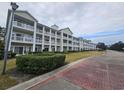 Building exterior showcasing landscaping and brick driveway at 1001 World Tour Blvd. # 205, Myrtle Beach, SC 29579