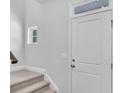 Front entry with white door, carpet stairs, and small window at 310 Sandridgebury Dr. # 40, Little River, SC 29566