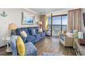 Living room with ocean view, comfy seating, and hardwood floors at 6900 N Ocean Blvd. # 1540, Myrtle Beach, SC 29572