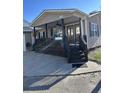 Tan house with a porch, dark brown steps, and attached garage at 6001-1774 S Kings Hwy., Myrtle Beach, SC 29575