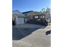 Tan house with a porch, dark brown steps, and attached garage at 6001-1774 S Kings Hwy., Myrtle Beach, SC 29575