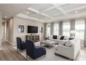 Open living room with coffered ceiling, neutral decor, and large windows at 7071 Denim Loop, Myrtle Beach, SC 29575