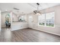 Bright dining room with hardwood floors, a kitchen view, and a chandelier at 140 Wimbledon Way # 140, Murrells Inlet, SC 29576