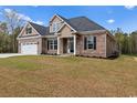 Two-story home with a brick and siding exterior, three-car garage, and spacious yard at 3329 Hughes Gasque Rd., Aynor, SC 29511