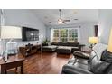 Open living area with sectional sofa, hardwood floors, and large window at 3604 Farmington Pl., Myrtle Beach, SC 29579