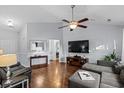 Spacious living room with hardwood floors, sectional sofa, and large TV at 3604 Farmington Pl., Myrtle Beach, SC 29579