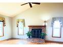 Spacious living room featuring a brick fireplace and vaulted ceiling at 611 Six Lakes Dr., Myrtle Beach, SC 29588