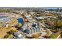 Aerial view showcasing Golf Glen Villas' setting near water and golf course at 1101 Possum Trot Rd. # A103, North Myrtle Beach, SC 29582